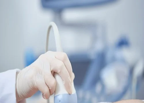 Crop closeup view of special medical device working with help of ultra sound and radiography. Planned observation with modern technologies preventing illnes. Concept of health care.